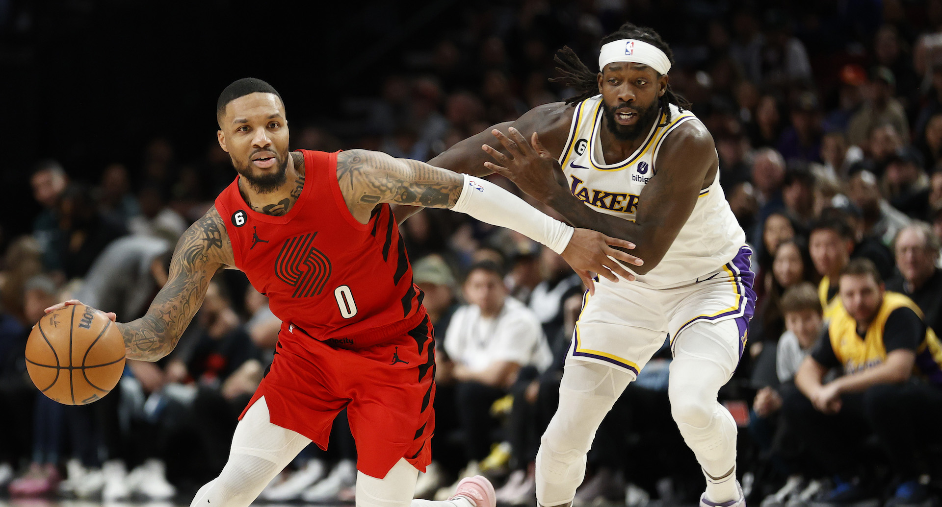 PORTLAND, OREGON - JANUARY 22: Damian Lillard #0 of the Portland Trail Blazers dribbles against Patrick Beverley #21 of the Los Angeles Lakers during the fourth quarter at Moda Center on January 22, 2023 in Portland, Oregon. NOTE TO USER: User expressly acknowledges and agrees that, by downloading and/or using this photograph, User is consenting to the terms and conditions of the Getty Images License Agreement. (Photo by Steph Chambers/Getty Images)